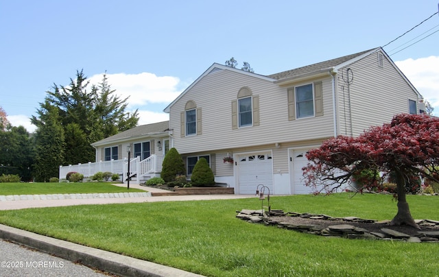 tri-level home with a front yard and a garage
