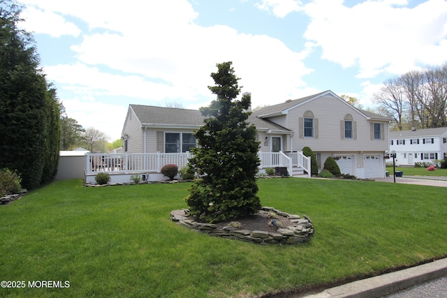 split level home with roof with shingles, a front lawn, concrete driveway, and an attached garage