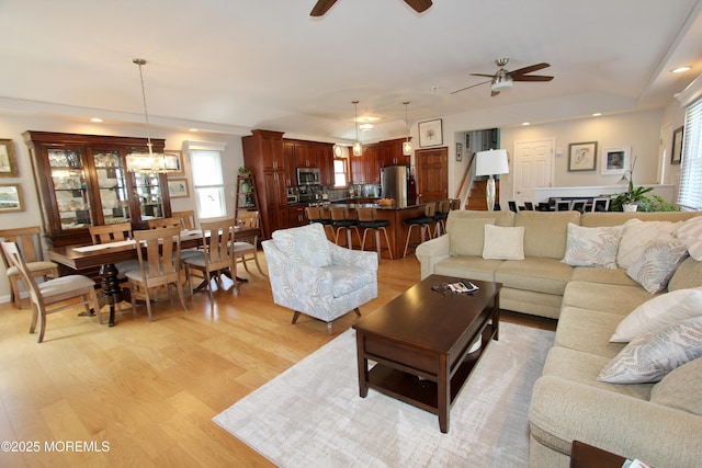 living room featuring a wealth of natural light, a ceiling fan, light wood finished floors, and recessed lighting