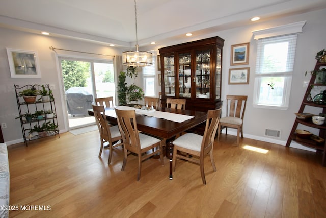 dining room featuring light wood-style flooring, visible vents, baseboards, recessed lighting, and a notable chandelier
