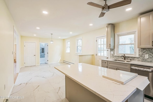 kitchen with dishwasher, baseboards, recessed lighting, and a sink