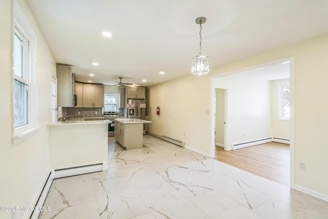 kitchen featuring recessed lighting, stainless steel appliances, light countertops, and marble finish floor