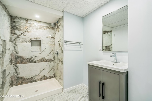 full bathroom featuring baseboards, a marble finish shower, marble finish floor, and vanity