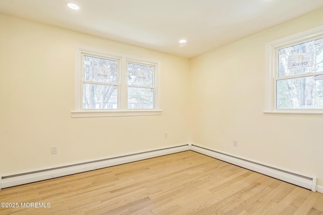 unfurnished room featuring recessed lighting, wood finished floors, and baseboards