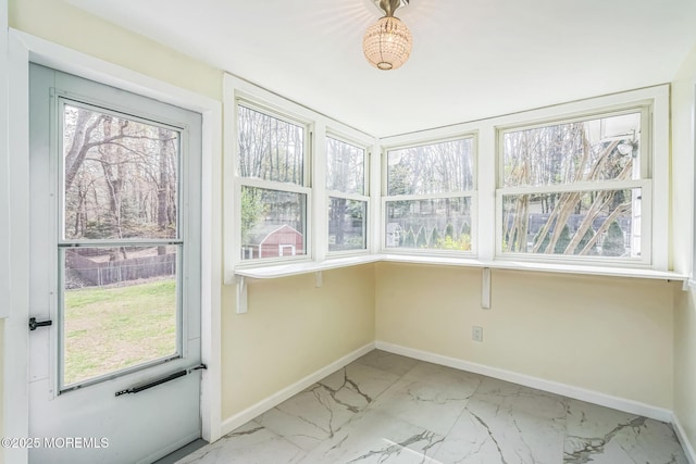 unfurnished sunroom with a wealth of natural light