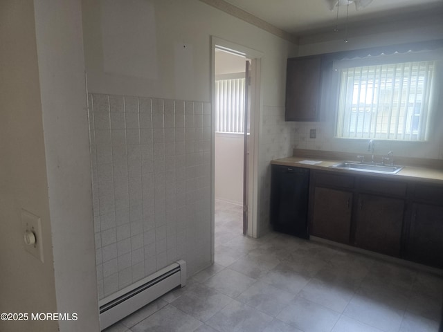 kitchen featuring tile walls, a sink, a healthy amount of sunlight, and a baseboard radiator
