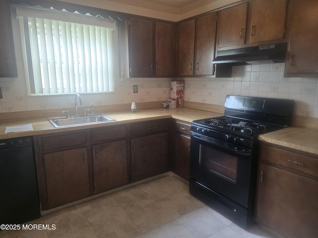 kitchen with black appliances, a sink, under cabinet range hood, and tasteful backsplash