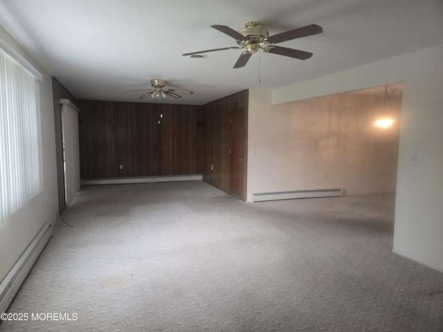 unfurnished room with light colored carpet, ceiling fan, a baseboard heating unit, and baseboard heating