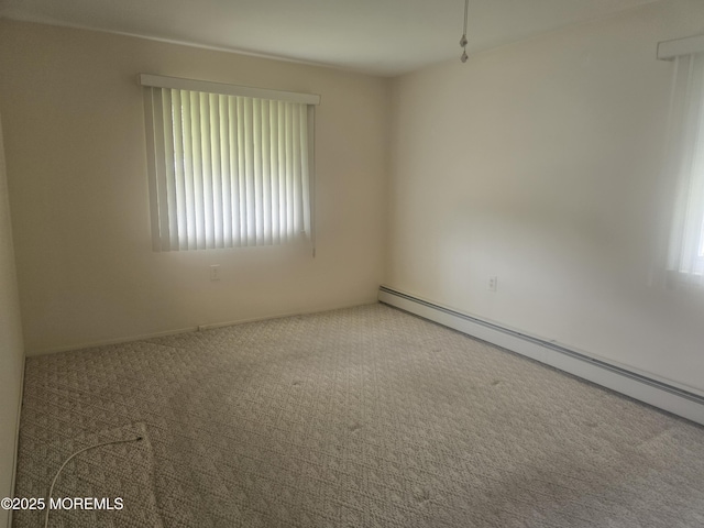 carpeted spare room with baseboard heating