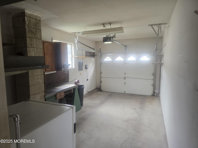 garage featuring electric panel and a garage door opener