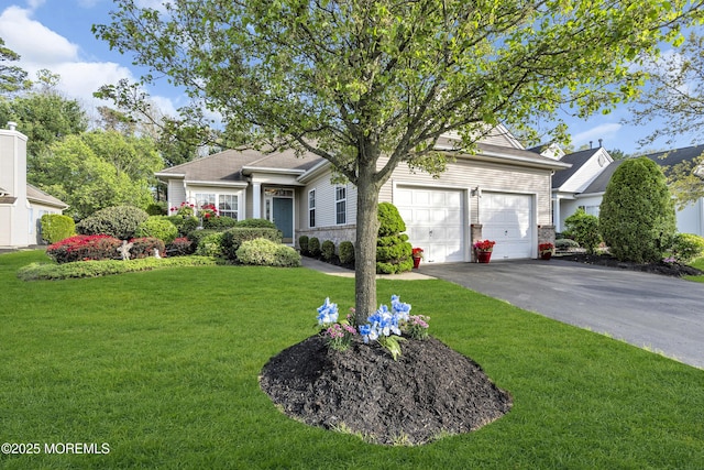 ranch-style home with a garage, a front lawn, and driveway