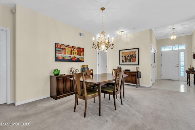 dining space featuring baseboards, a chandelier, light carpet, and visible vents