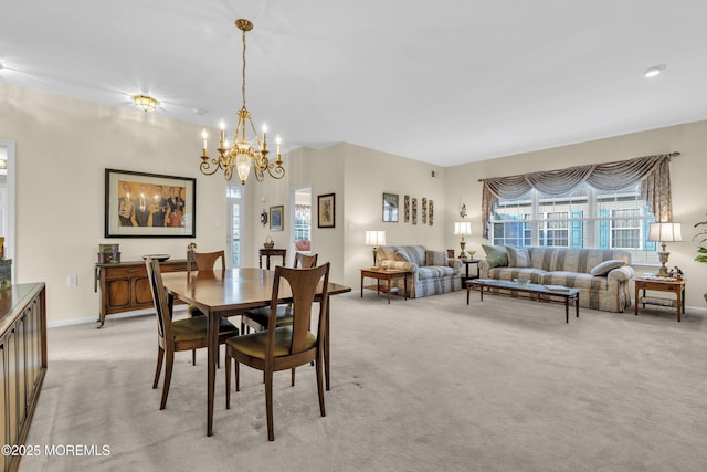 dining area with light colored carpet, baseboards, a chandelier, and a wealth of natural light
