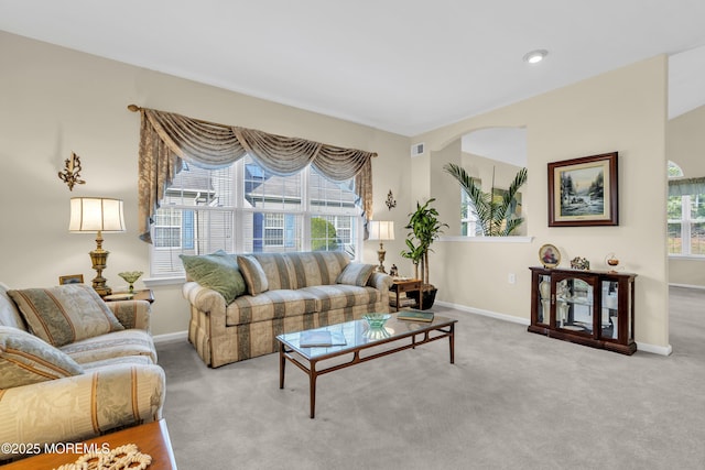 carpeted living room with baseboards and visible vents