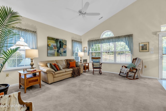 carpeted living area with baseboards, a ceiling fan, visible vents, and high vaulted ceiling