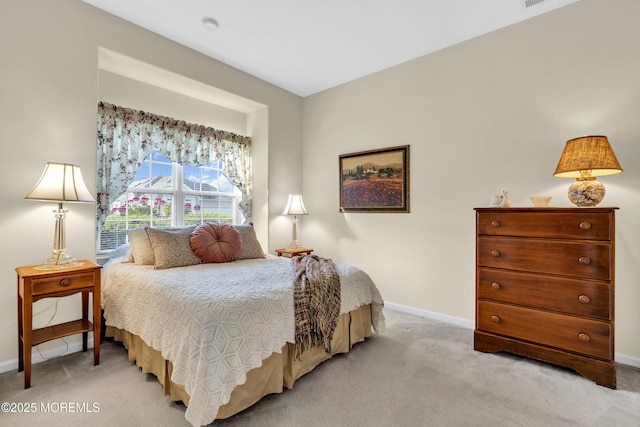 bedroom with baseboards and light carpet