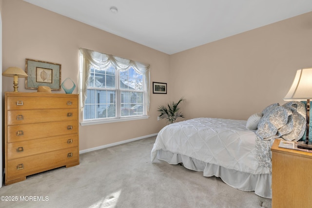 carpeted bedroom featuring baseboards