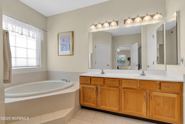 ensuite bathroom featuring double vanity, tile patterned flooring, a sink, and a bath