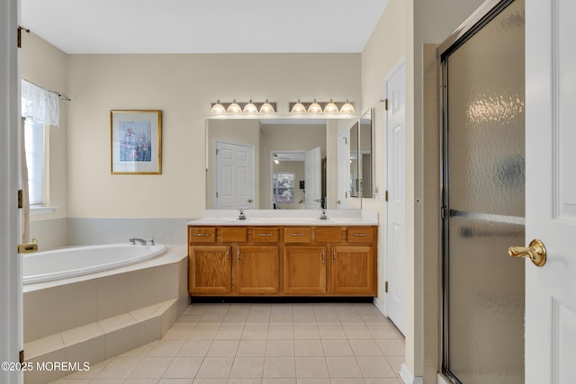 bathroom with a sink, double vanity, tile patterned floors, a garden tub, and a stall shower