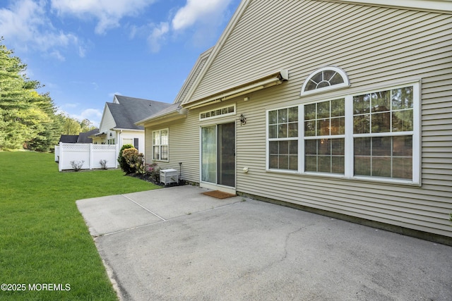 back of house with a lawn, a patio, and fence