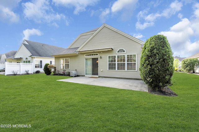 back of house with fence, a patio, and a yard