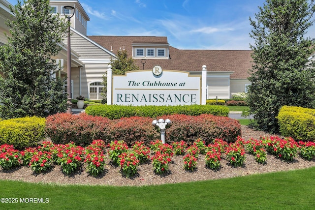 community / neighborhood sign with a yard