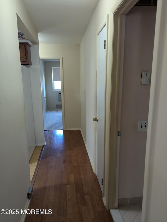 hall with wood finished floors and baseboards