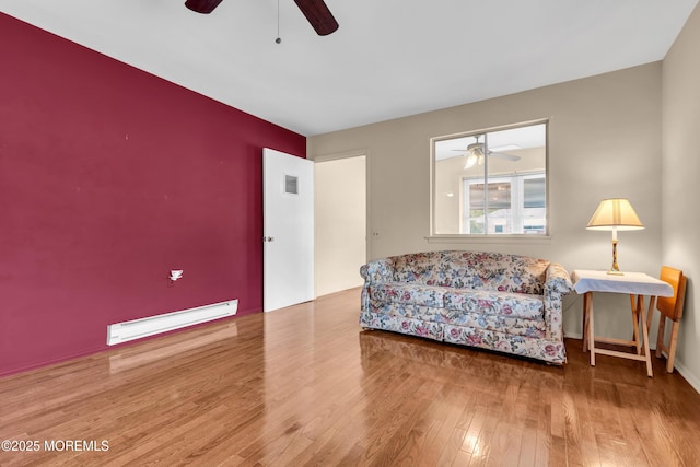 8A Lafayette Dr, Whiting, NJ 08759 - living area with wood finished floors, a ceiling fan, and a baseboard heating unit