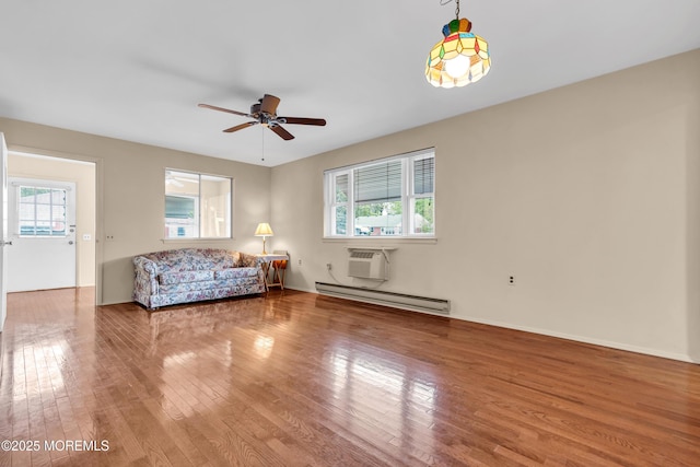 8A Lafayette Dr, Whiting, NJ 08759 - living area with a ceiling fan, plenty of natural light, wood finished floors, and baseboard heating