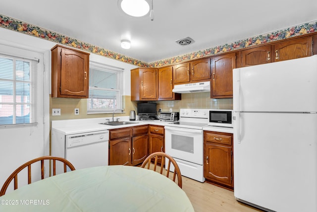 8A Lafayette Dr, Whiting, NJ 08759 - kitchen with a sink, white appliances, light wood-type flooring, backsplash, and under cabinet range hood