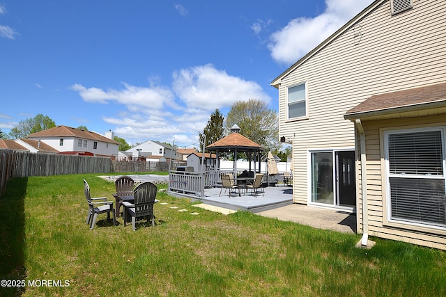 view of yard featuring a gazebo, a residential view, a fenced backyard, and a patio area