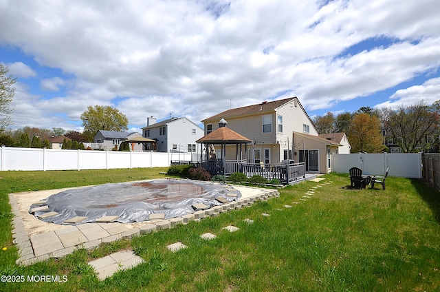 back of house featuring a lawn, a gazebo, a fenced backyard, and a patio area