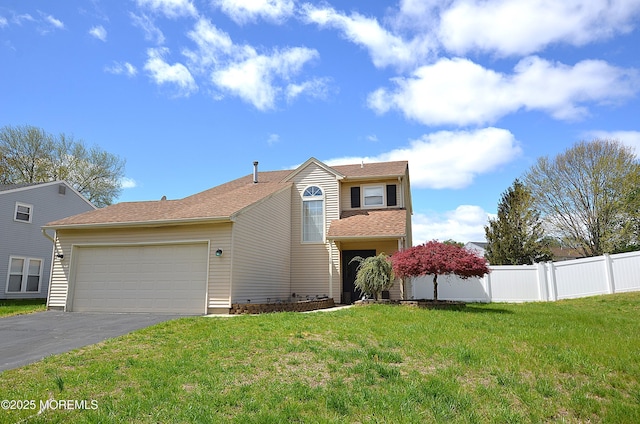 view of front facade featuring a garage, a front lawn, fence, and driveway
