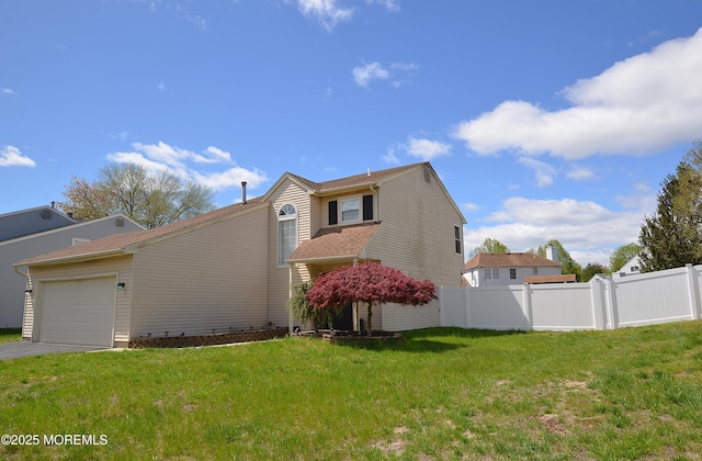 view of side of home with a yard, fence, driveway, and a garage