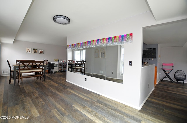 dining room featuring baseboards, wood finished floors, and visible vents