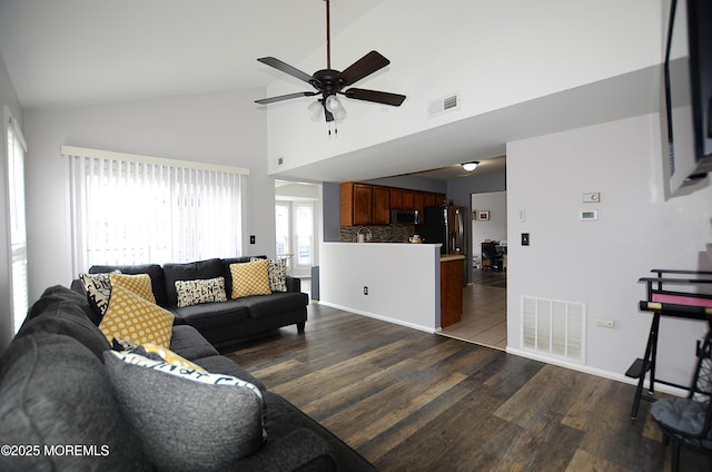 living room featuring high vaulted ceiling, ceiling fan, dark wood-style floors, and visible vents