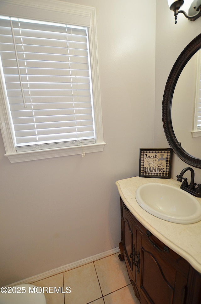 bathroom featuring baseboards, tile patterned flooring, and vanity
