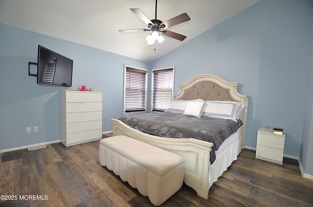 bedroom featuring baseboards, wood finished floors, and vaulted ceiling