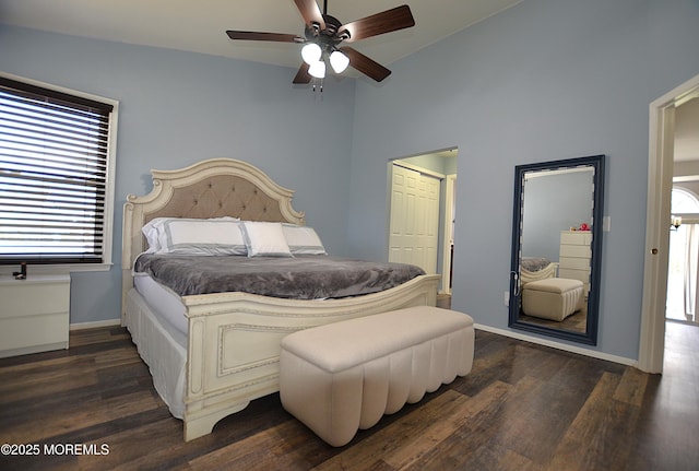 bedroom with baseboards, multiple windows, dark wood-style floors, and lofted ceiling