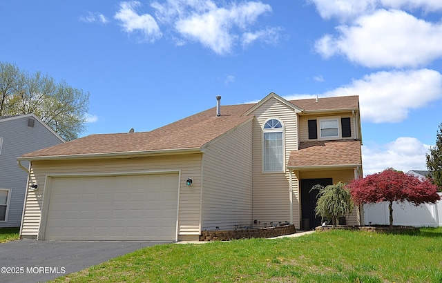 view of front facade with an attached garage, driveway, and a front yard