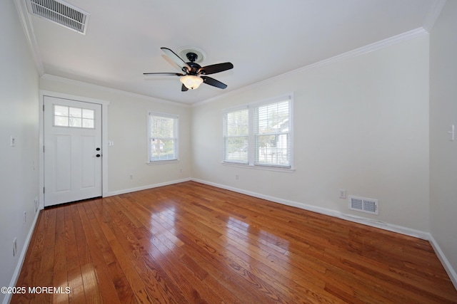 entrance foyer with visible vents, plenty of natural light, and hardwood / wood-style flooring