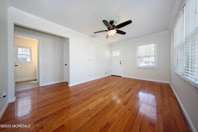 unfurnished living room featuring baseboards, ceiling fan, crown molding, and light wood-style flooring