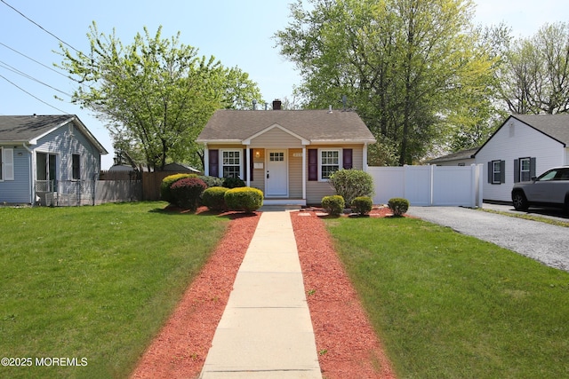 bungalow featuring a front lawn, a chimney, and fence