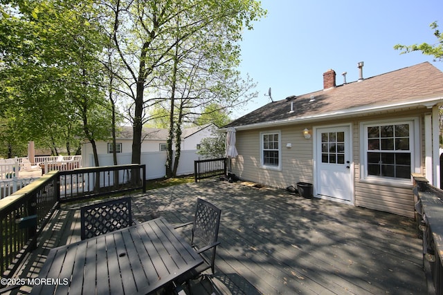 deck featuring fence and outdoor dining space