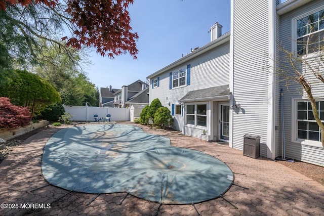 view of pool with a patio, central AC, and a fenced backyard
