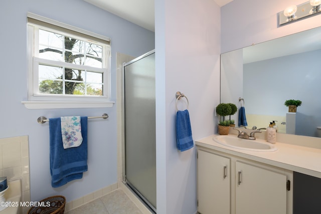 full bath with tile patterned floors, a shower stall, and vanity
