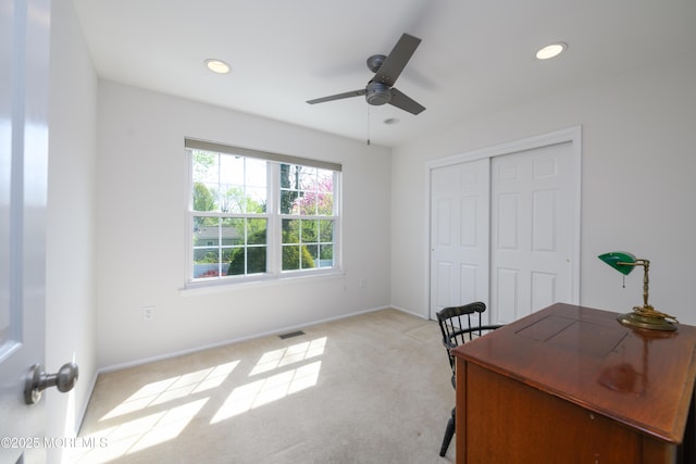 home office featuring recessed lighting, a ceiling fan, visible vents, baseboards, and light colored carpet