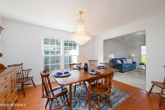 dining room featuring a notable chandelier and wood finished floors