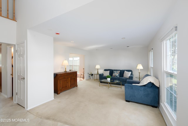 living room with baseboards and light carpet