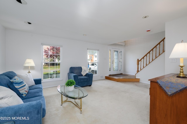 carpeted living area with recessed lighting, visible vents, stairway, and baseboards